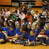 Livsey School Science Olympiad team seated on basketball court at Druid Hills Middle School during opening ceremony