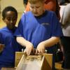 Samuel launches winning boat in paddle boat competition finishing in 7 seconds, 3 seconds ahead of the second place boat