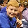 Samuel proudly shows gold medal for paddle boat racing