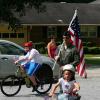 Samuel rides his bike in the parade