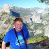 Samuel at Washburn Point with Half Dome and the Nevada and Vernal waterfalls in the background, Yosemite