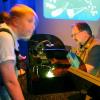 Monterey Aquarium volunteer explaining jellfish life cycle with projection microscope