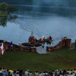 Chief approaches in canoe to light the camp bonfire. July 18, 2014