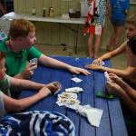 Sam plays cards with Nate, Jake, and Aaron at NUSC vs Winding Vista swim meet,
June 3, 2014