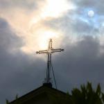 Cross on St. Louis Cathedral and moon as clouds break up