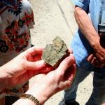 Julia examines ore sample for silver, July 8, 2014