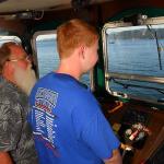 Sam learns about operating a boat from the captain of the Shawnodese, who pilots freighters and research vessels on the high seas during the off-season, July 10, 2014